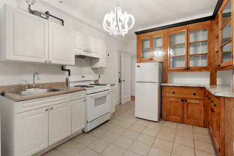 a kitchen with stainless steel appliances granite countertop a refrigerator sink and cabinets