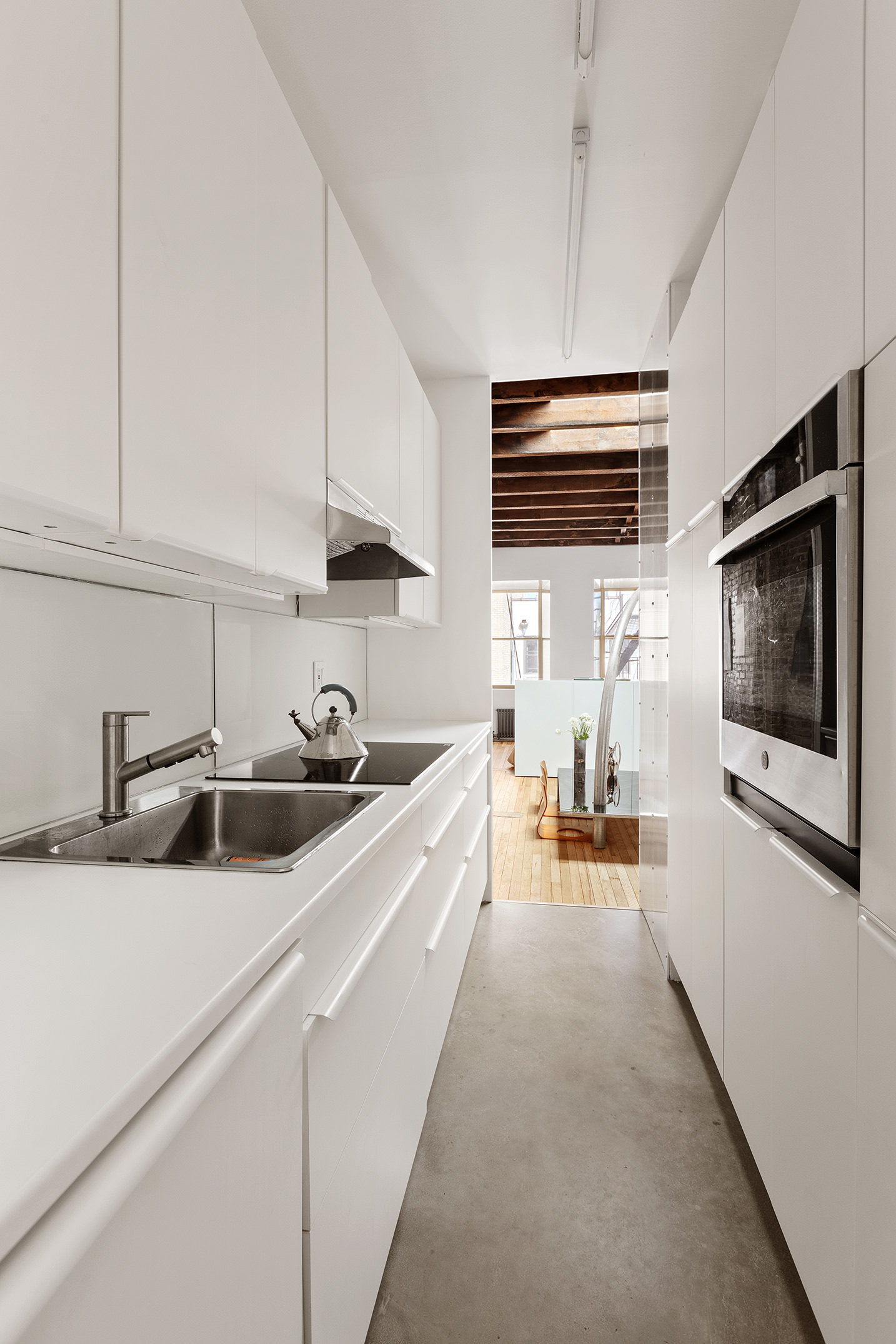 186 East 2nd Street, Unit 16 Manhattan, NY 10009 - Photo 3 of 17 a kitchen with stainless steel appliances a sink stove and cabinets