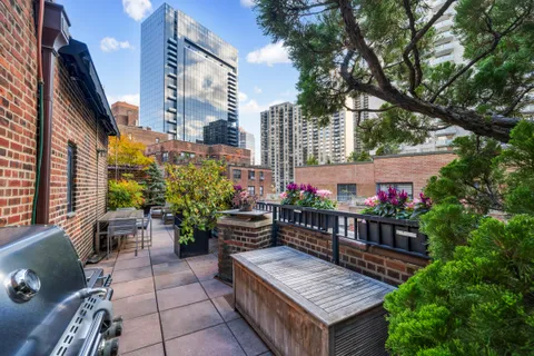 a wooden bench sitting in front of a building