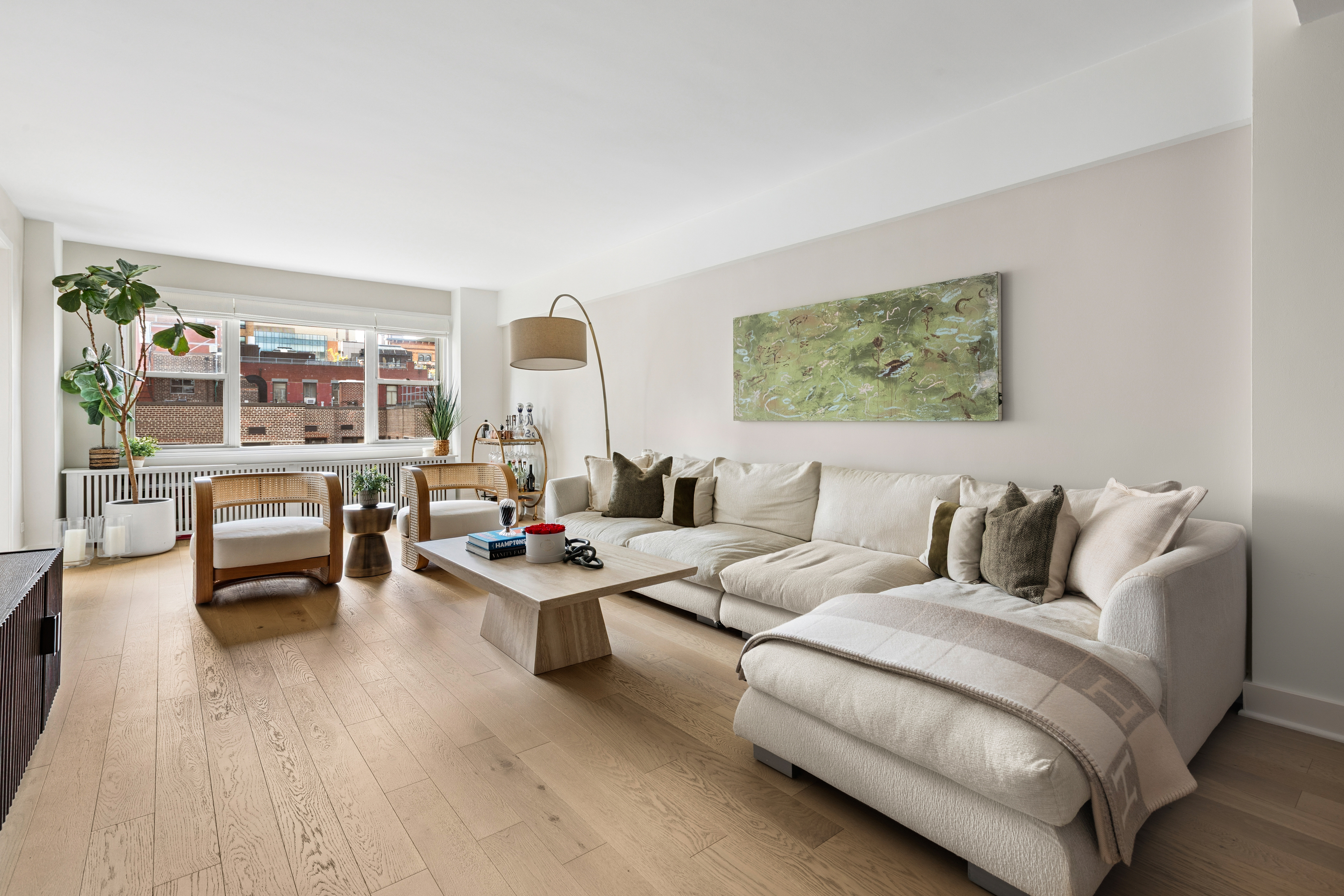 40 East 9th Street, Unit 7L Manhattan, NY 10003 - Photo 4 of 17 a living room with furniture and large window
