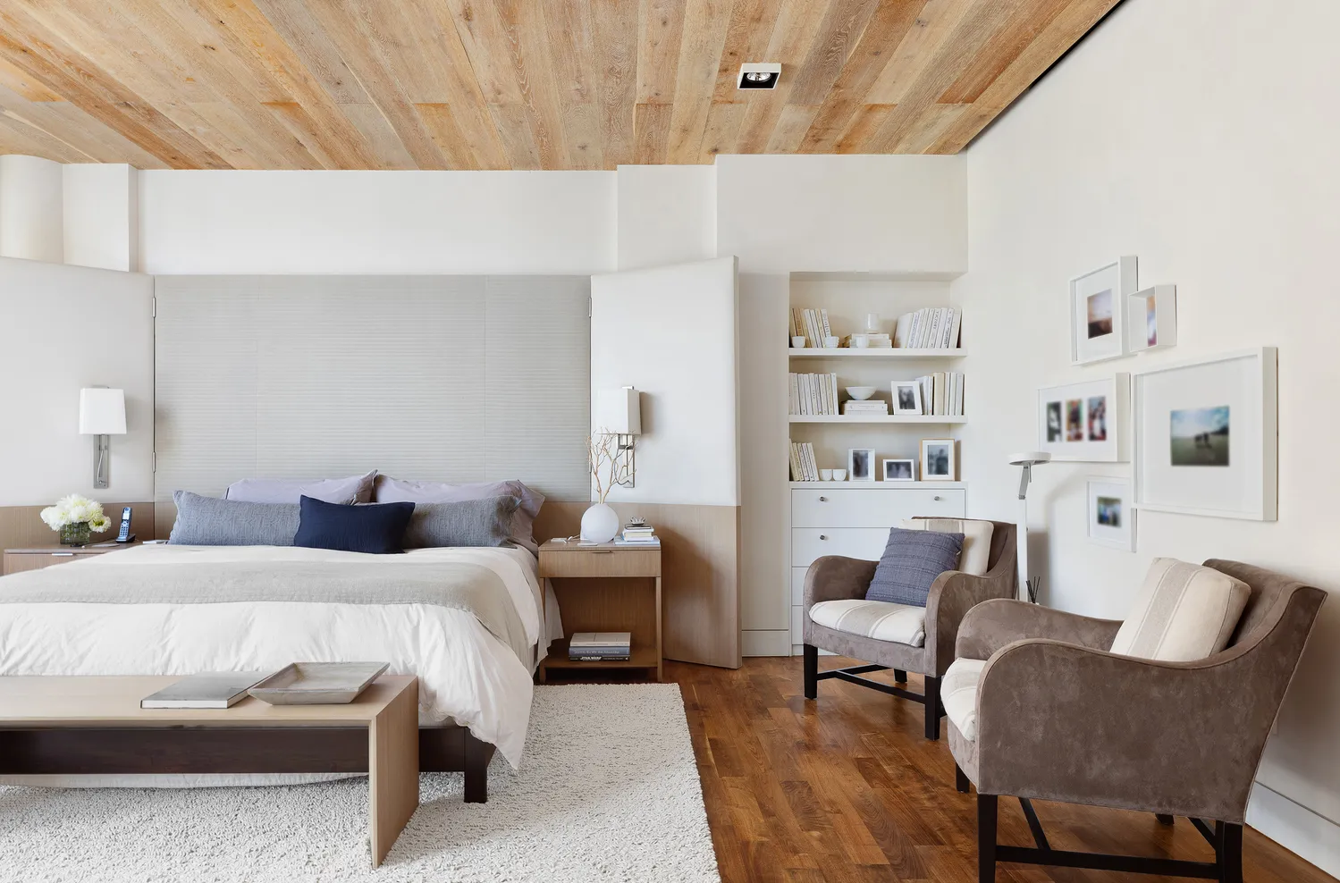 a bedroom with a bed a bookshelf and a bookshelf