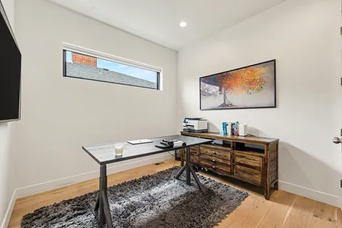 a reading room with furniture and rug