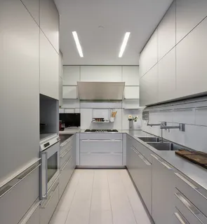 a kitchen with a sink stainless steel appliances and cabinets