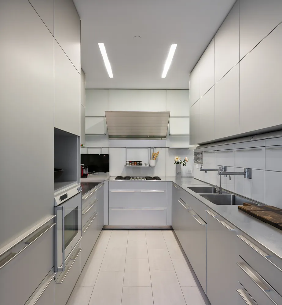 a kitchen with a sink stainless steel appliances and cabinets