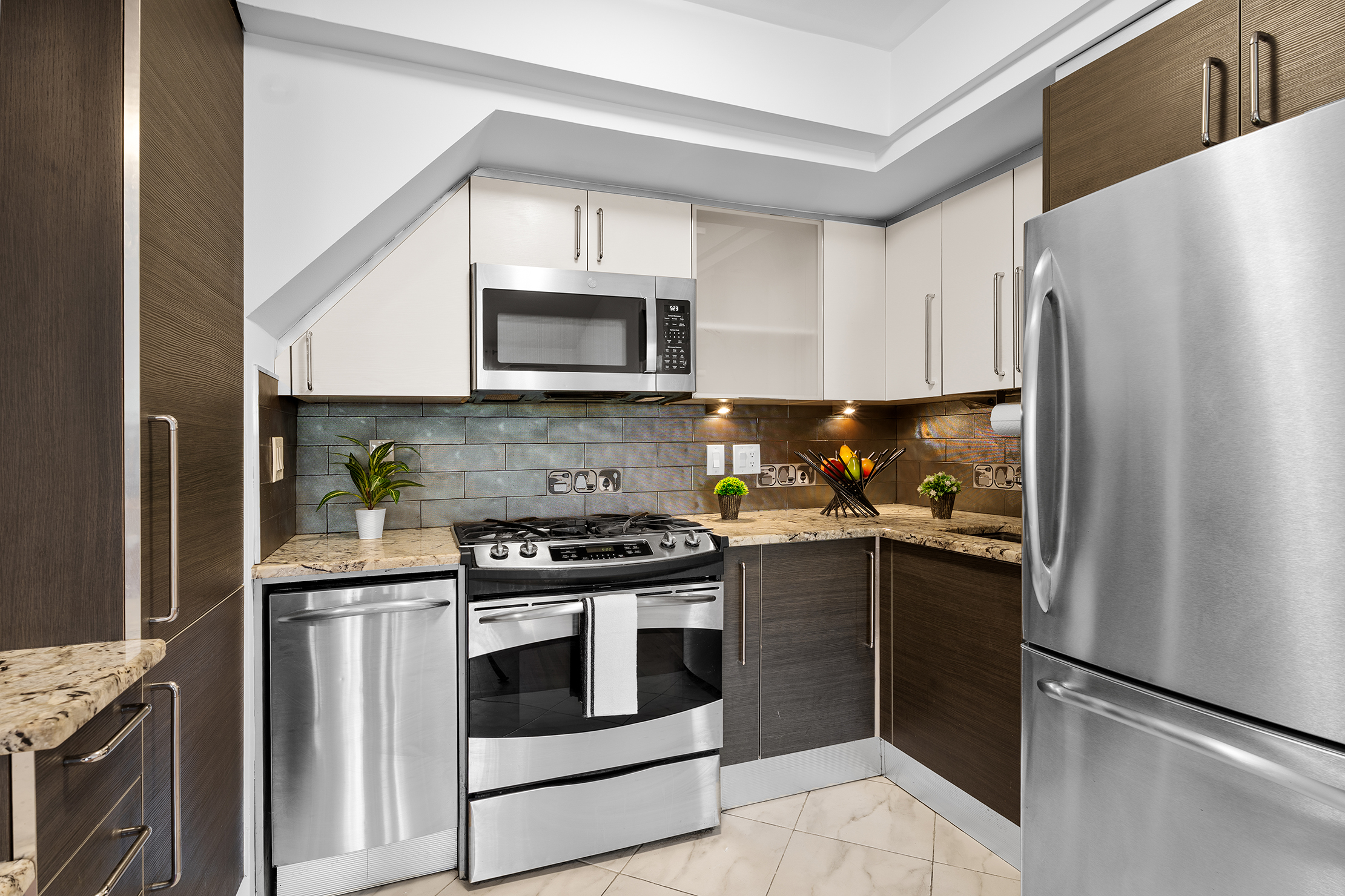 336 99th Street, Unit 15 Brooklyn, NY 11209 - Photo 3 of 7 a kitchen with stainless steel appliances granite countertop a refrigerator stove and microwave