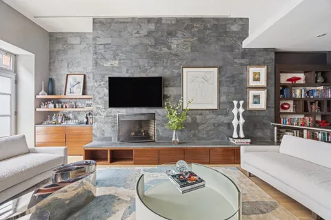 a living room with fireplace furniture and a flat screen tv