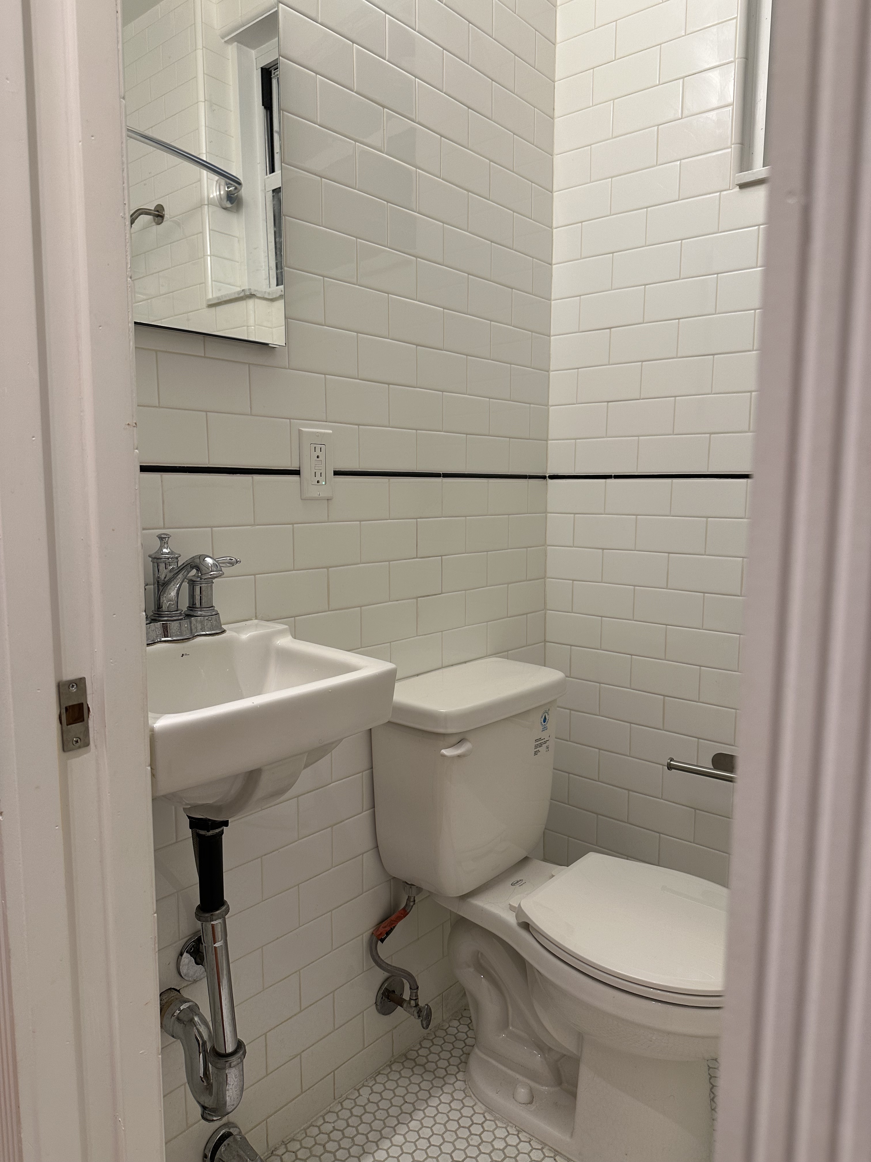 459 West 35th Street, Unit 1E Manhattan, NY 10001 - Photo 9 of 18 a bathroom with a toilet a sink and mirror