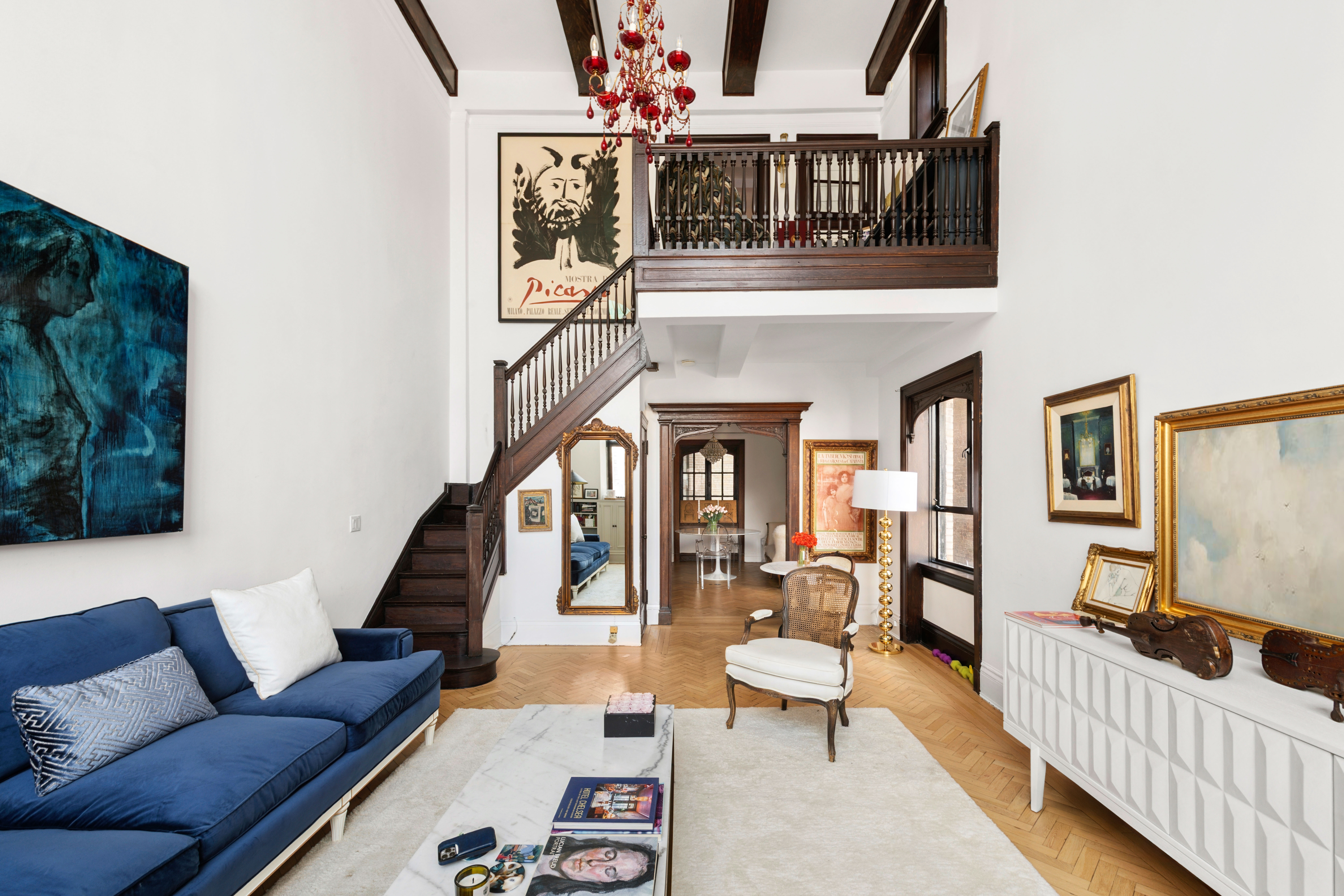 1 West 67th Street, Unit 608 Manhattan, NY 10023 - Photo 3 of 16 a living room with furniture and a flat screen tv