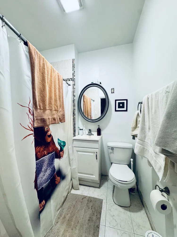 a bathroom with a toilet a sink and a mirror