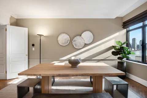 a kitchen with a stove a refrigerator a sink a dining table and chair