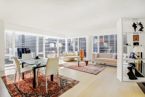 a living room with fireplace furniture and a large window