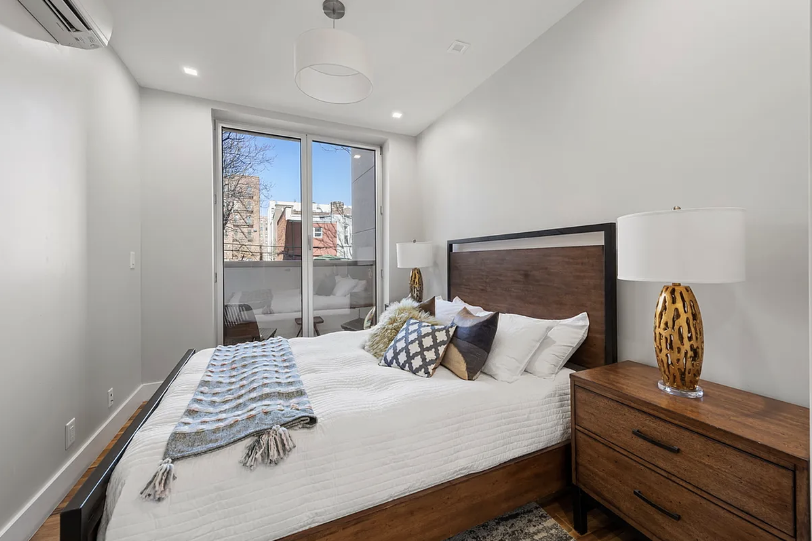 371 Lincoln Road, Unit 2 Brooklyn, NY 11225 - Photo 8 of 19 a bedroom with a bed and wooden floor