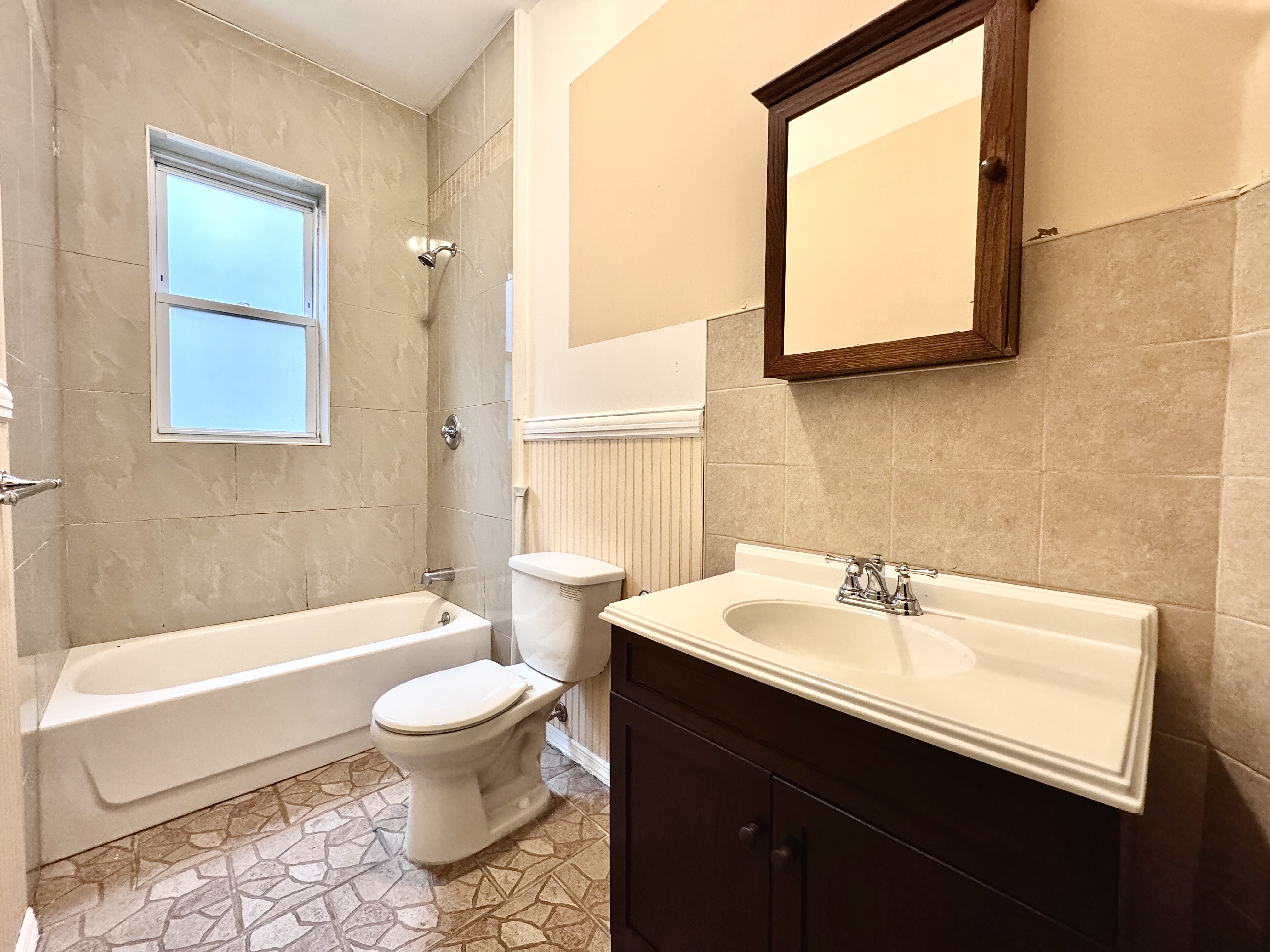 497 Park Place, Unit 4 Brooklyn, NY 11238 - Photo 13 of 14 a bathroom with a sink a toilet and a mirror
