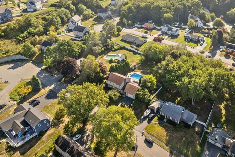 an aerial view of residential houses with outdoor space