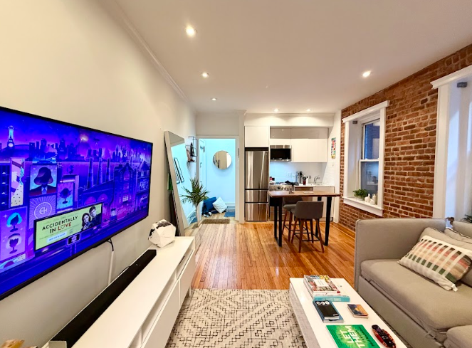 223 East 50th Street, Unit 1C Manhattan, NY 10022 - Photo 3 of 10 a living room with furniture and a wooden floor