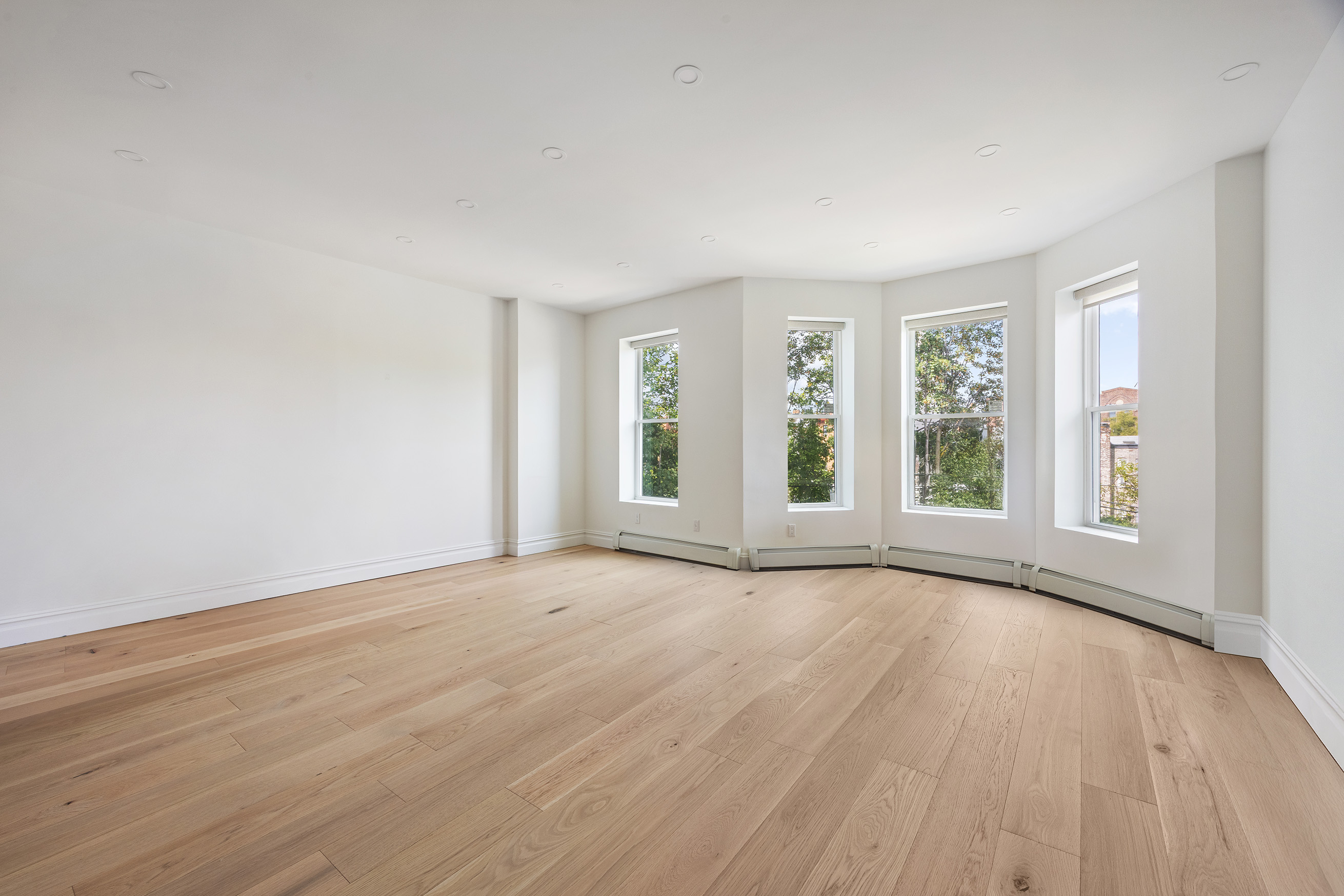 1423 Park Place Brooklyn, NY 11213 - Photo 12 of 17 a view of an empty room with a window and wooden floor