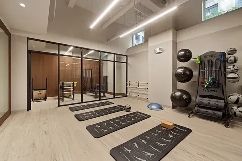 a view of livingroom with furniture and gym equipment