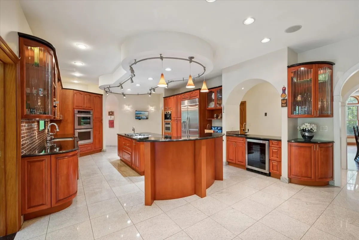 a kitchen with stainless steel appliances granite countertop a refrigerator and a stove