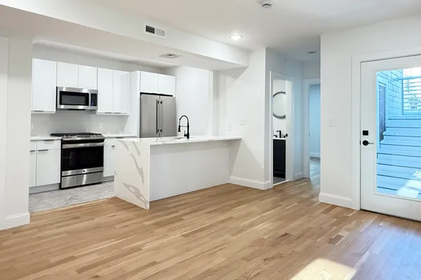 a kitchen with stainless steel appliances granite countertop a refrigerator and a stove top oven