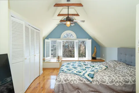 a bedroom with a bed and a large window