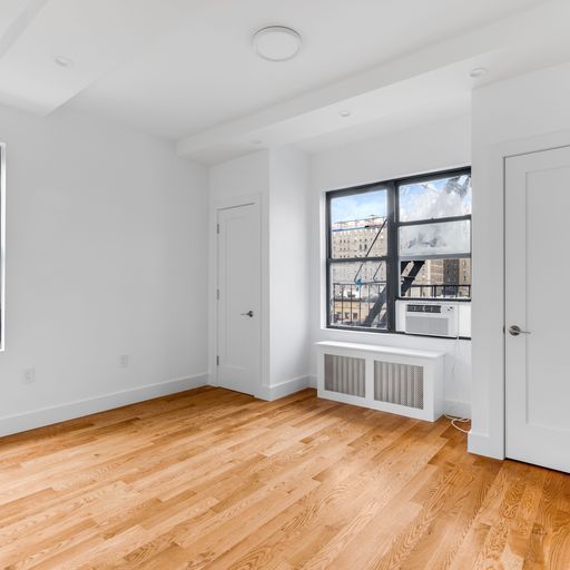 317 West 87th Street, Unit 8C Manhattan, NY 10024 - Photo 7 of 9 an empty room with wooden floor and windows