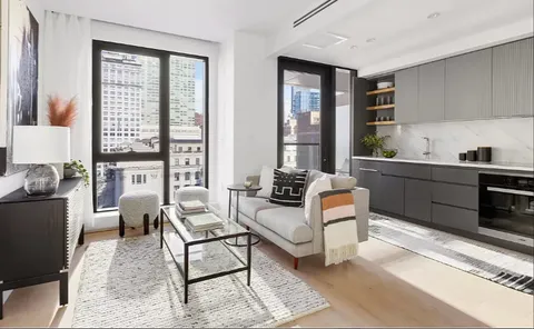 a living room with furniture and large windows
