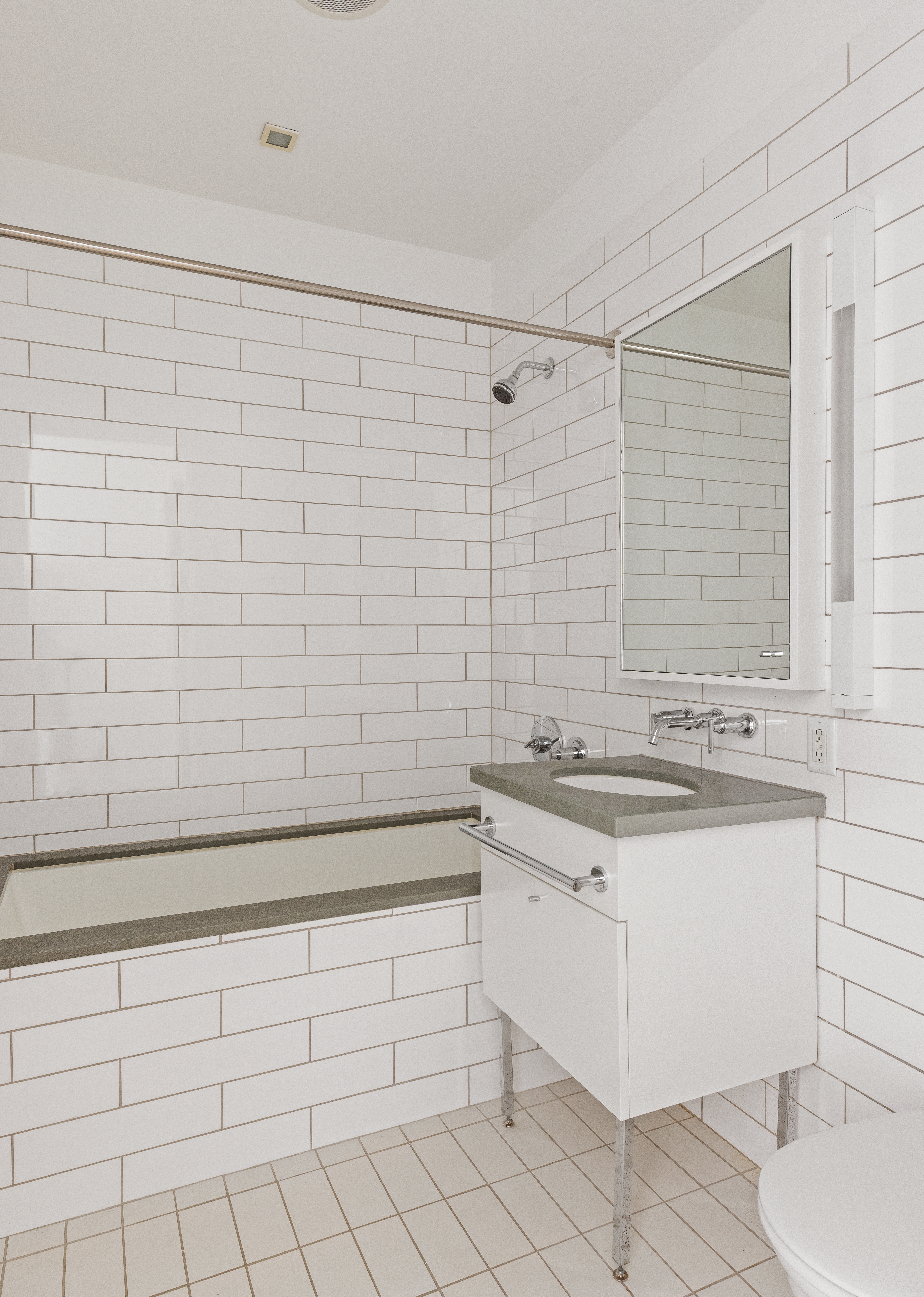 330 Spring Street, Unit 6A Manhattan, NY 10013 - Photo 9 of 11 a bathroom with a sink a toilet and tub