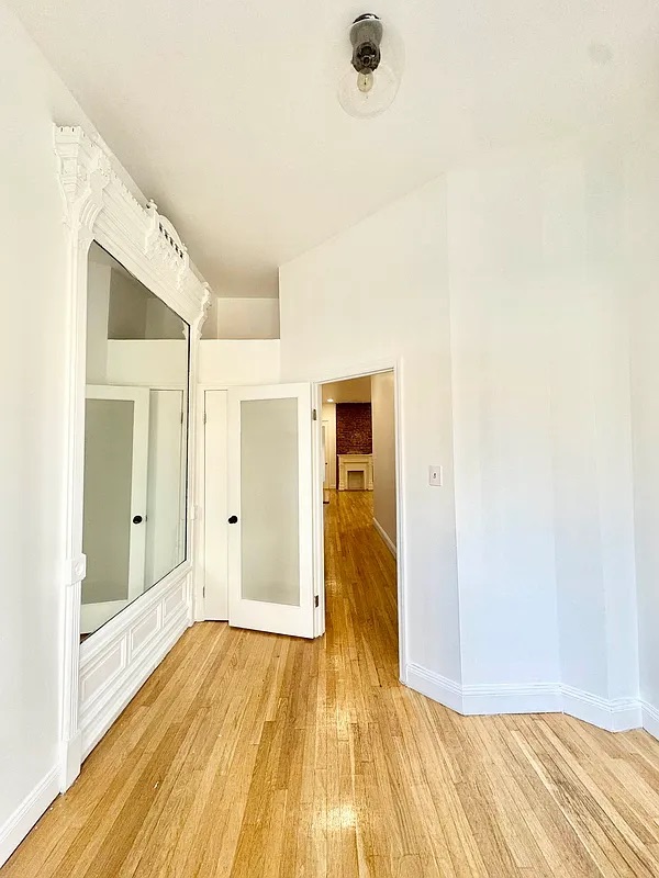238 Gates Avenue, Unit 2 Brooklyn, NY 11238 - Photo 10 of 13 a view of a room with wooden floor and a ceiling fan