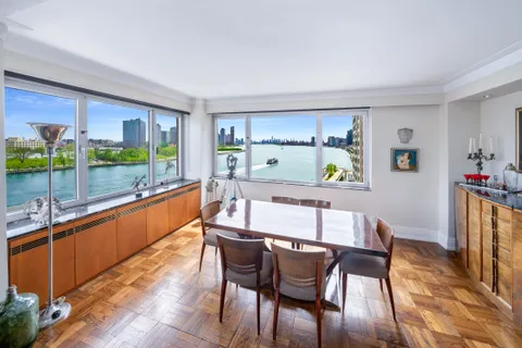 a dining room with furniture a window and a rug
