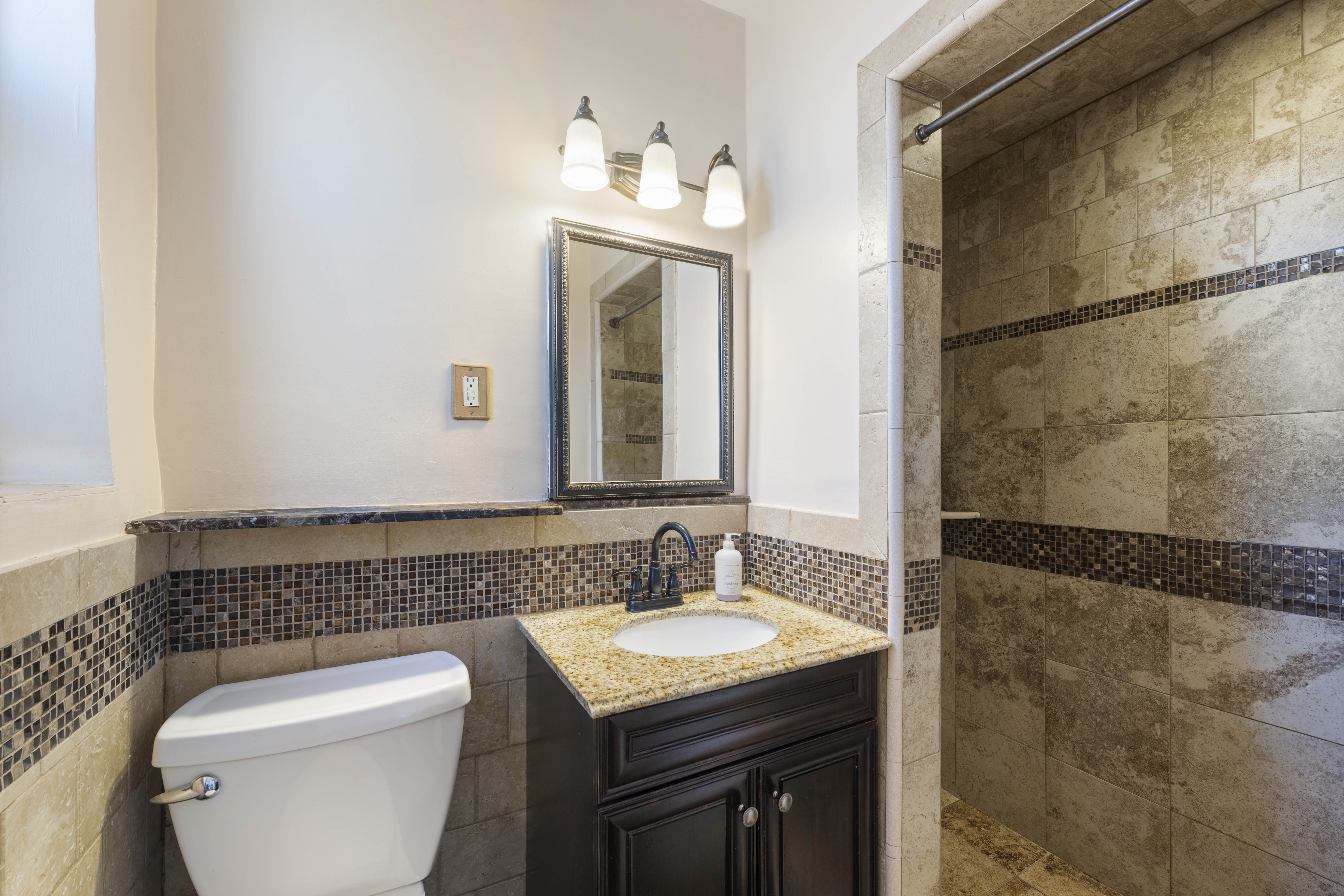 3475 Greystone Avenue, Unit 7B Bronx, NY 10463 - Photo 10 of 13 a bathroom with a granite countertop sink toilet and shower