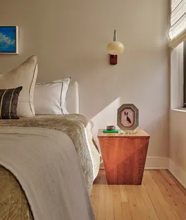 a bedroom with bed and wooden floor