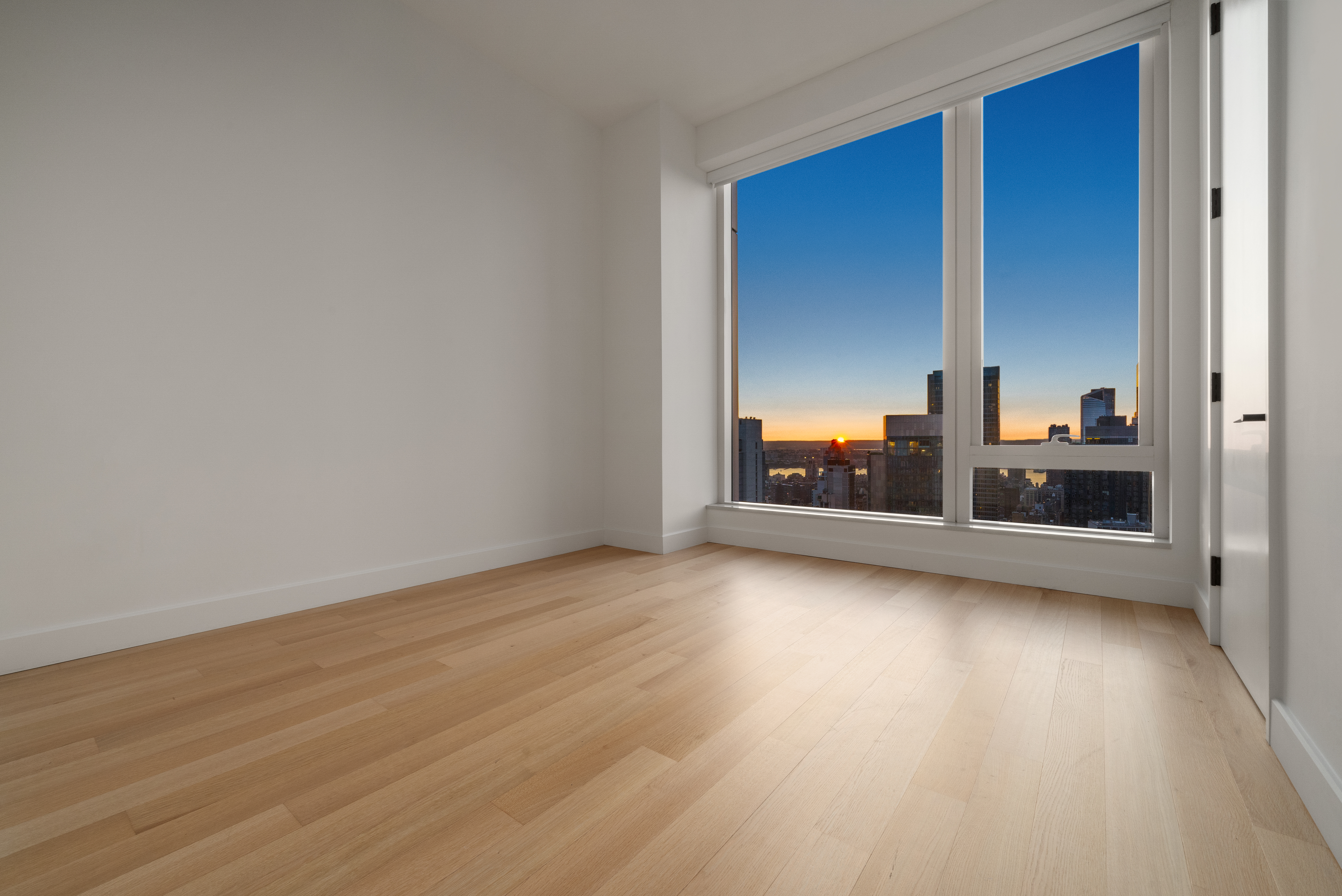 15 East 30th Street, Unit 42A Manhattan, NY 10016 - Photo 7 of 13 a view of a room with wooden floor and windows
