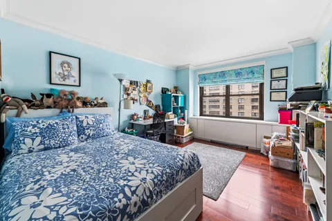 a bed room with furniture and a wooden floor