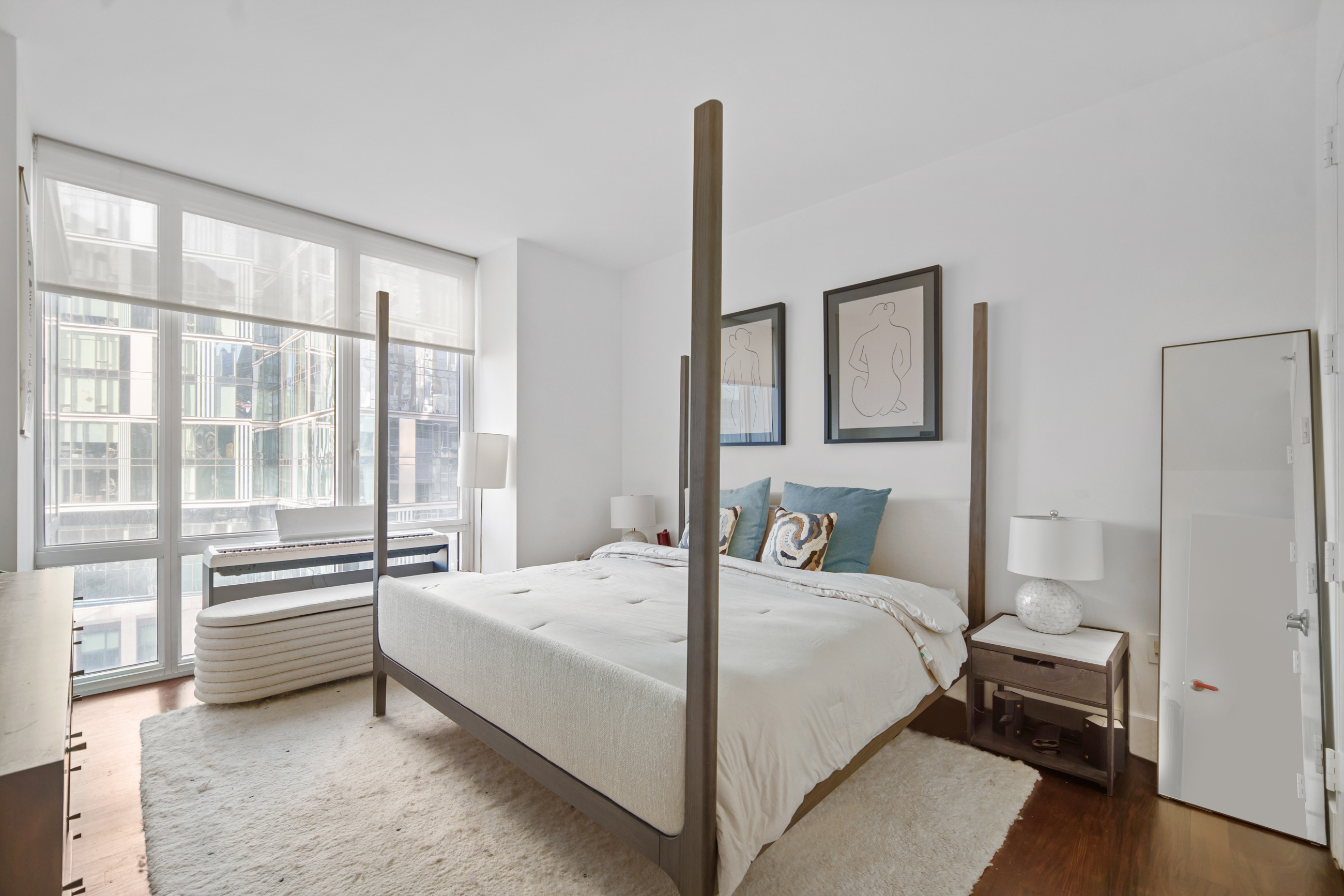 10 West End Avenue, Unit 11G Manhattan, NY 10023 - Photo 5 of 9 a bedroom with a bed and a large window