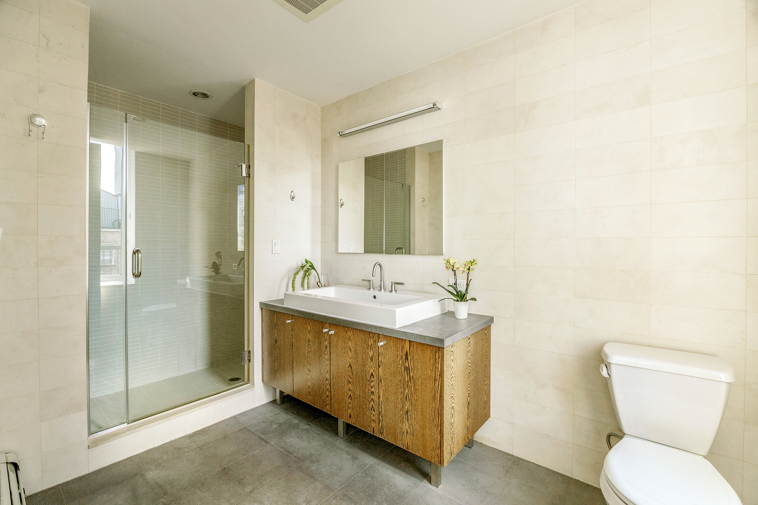 26 Broadway, Unit 704 Brooklyn, NY 11249 - Photo 9 of 20 a bathroom with a toilet sink and shower