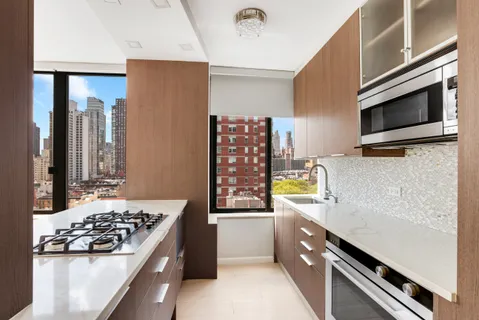 a kitchen with stainless steel appliances a stove a sink and a refrigerator