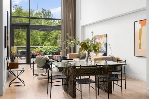 a view of a dining room with furniture window and outside view