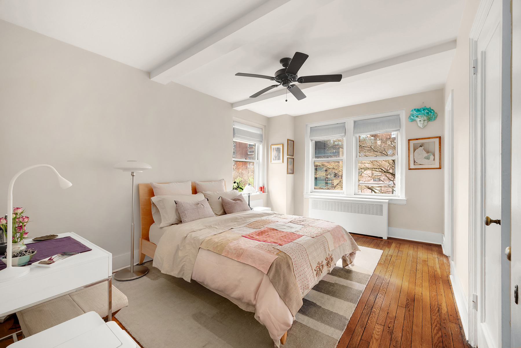 400 East 59th Street, Unit 3G Manhattan, NY 10022 - Photo 3 of 7 a bedroom with a bed a dresser and a window