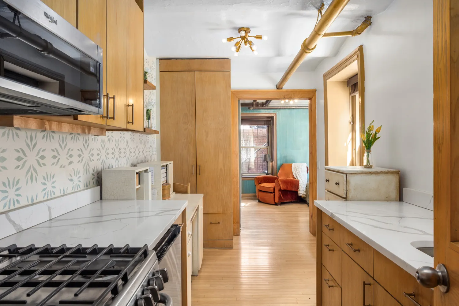 a kitchen with a stove a sink and a refrigerator