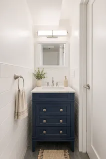 a bathroom with a sink vanity and mirror