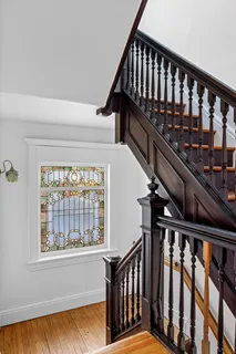 a view of staircase with railing and a window