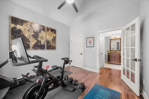 a kitchen with stainless steel appliances kitchen island granite countertop a table chairs and a refrigerator