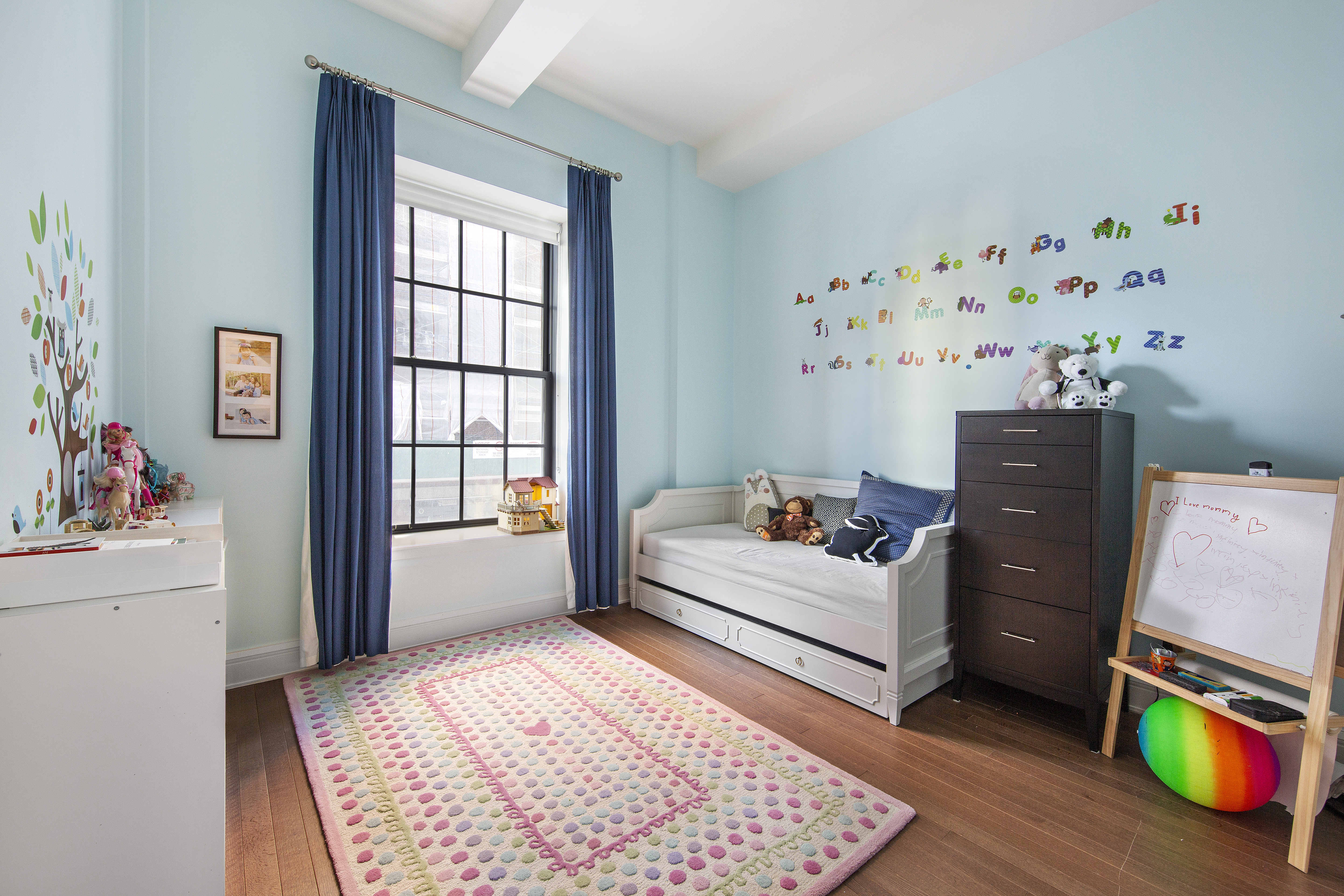 160 West 12th Street, Unit 28 Manhattan, NY 10011 - Photo 7 of 9 a living room with furniture and a window