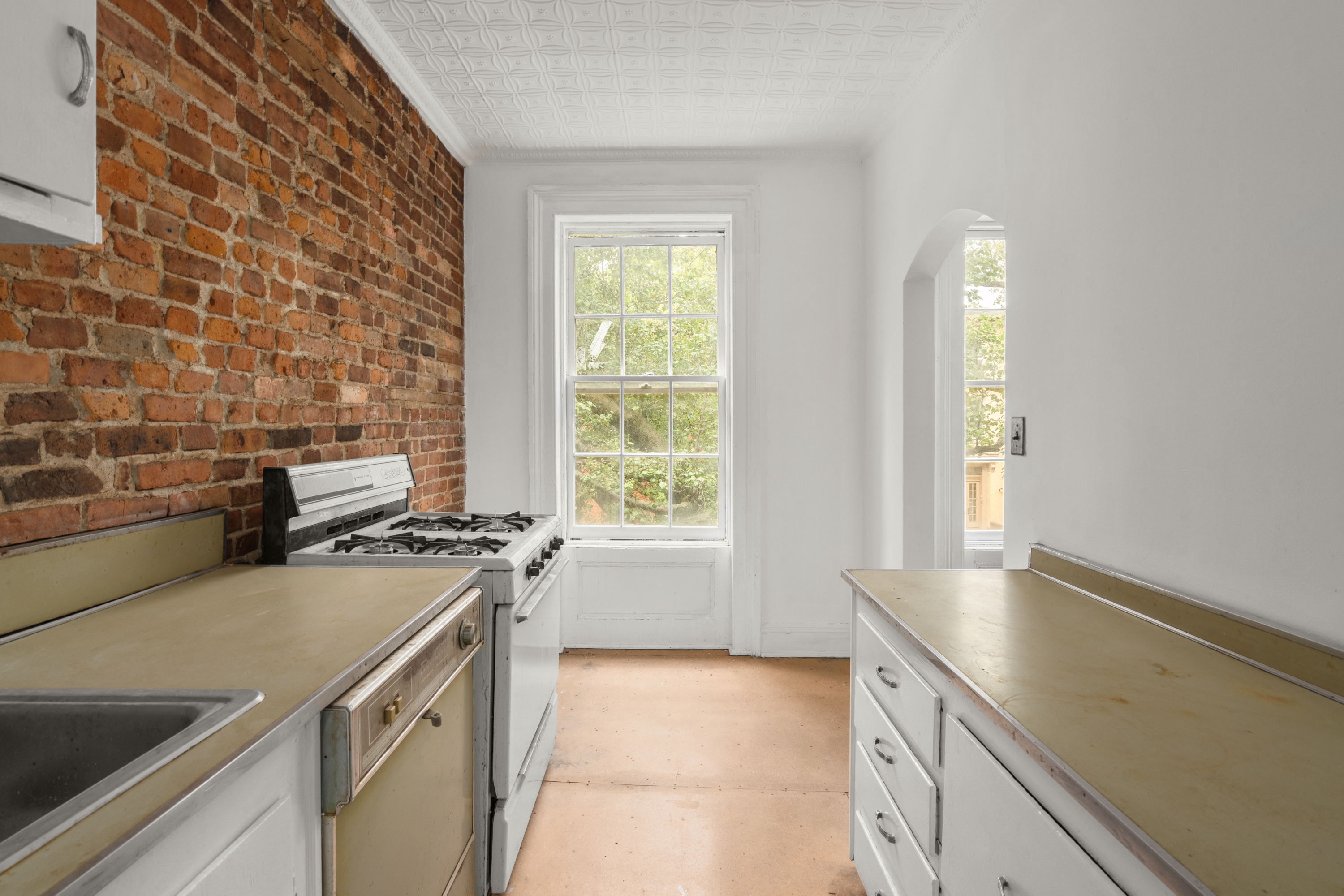 217 Dean Street Brooklyn, NY 11217 - Photo 12 of 26 a kitchen with a stove a sink and a window