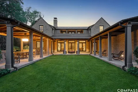a view of a house with a yard and porch