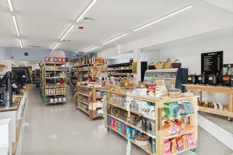 a view of a hallway and a livingroom with furniture