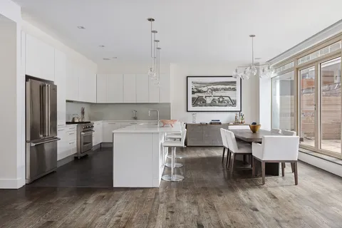 a view of kitchen with furniture and wooden floor