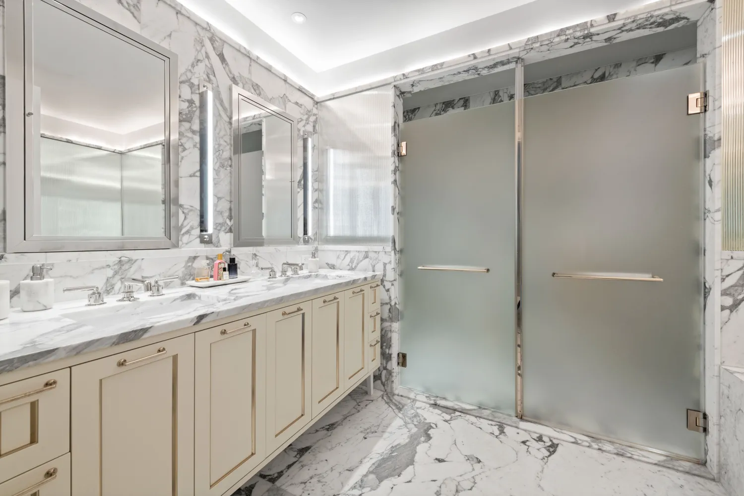 a bathroom with a double vanity sink mirror and shower