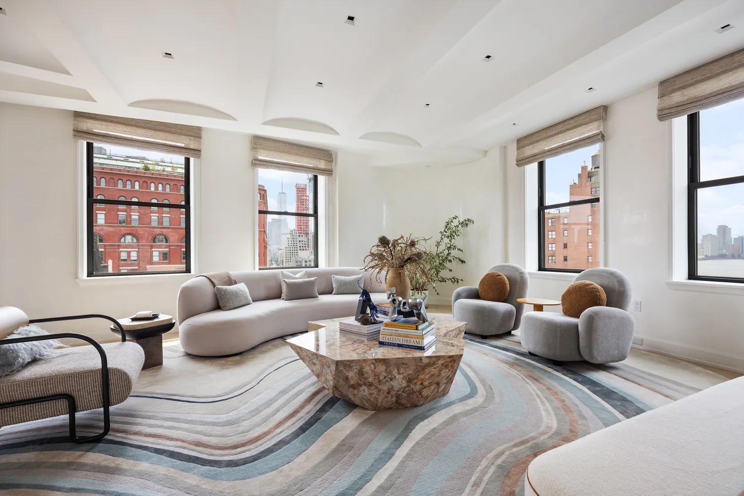 a living room with furniture potted plant and windows