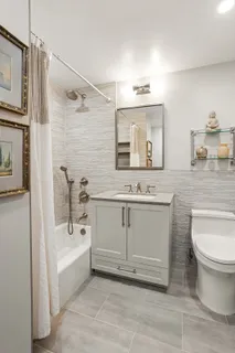 a bathroom with a sink a toilet and bathtub